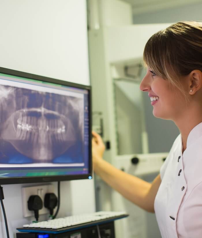 Dental team member reviewing all digital x-rays