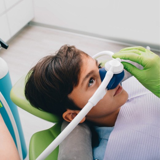Boy using nitrous oxide dental sedation for kids in Papillion 