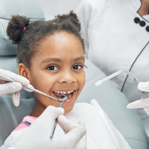 a girl undergoing a dental checkup to avoid an emergency