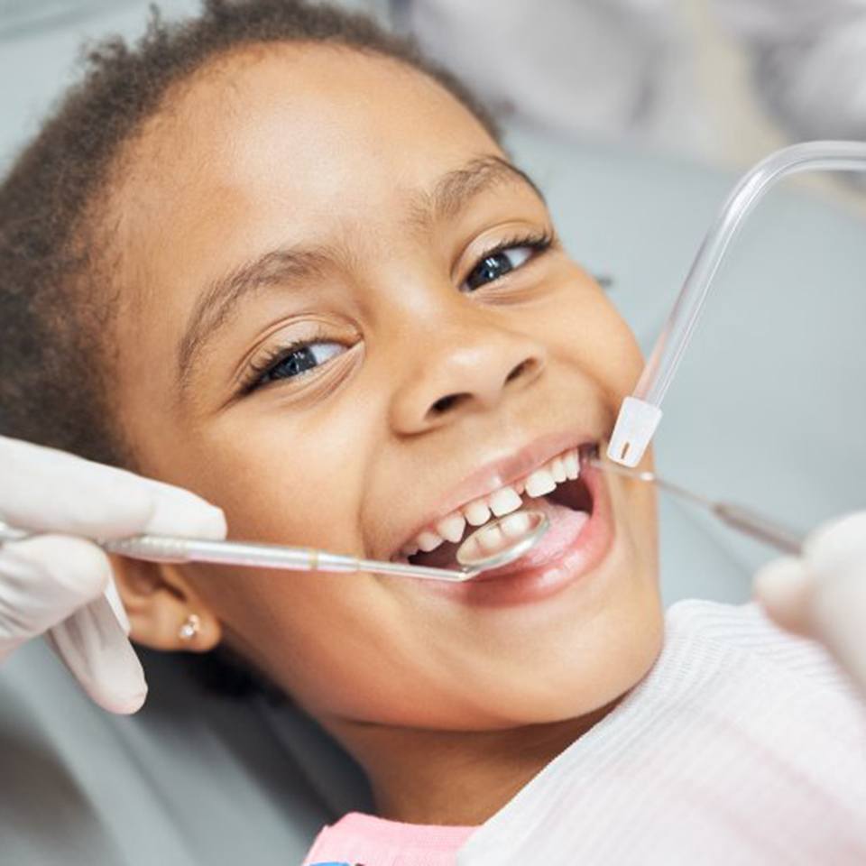 a child patient smiling during her dental appointment