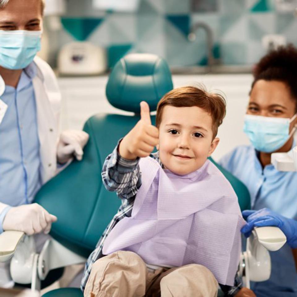 a child patient giving a thumbs-up