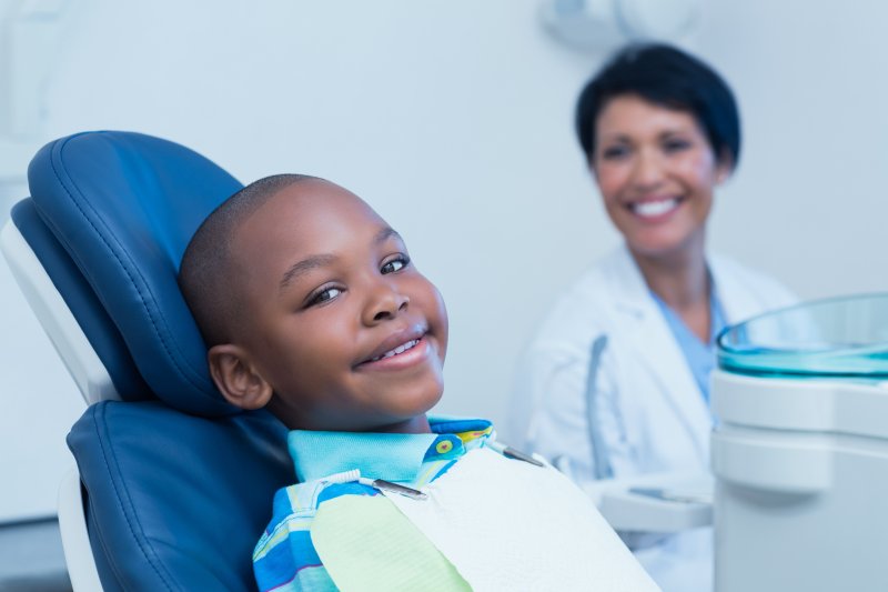 Child patient smiling with their dental crown