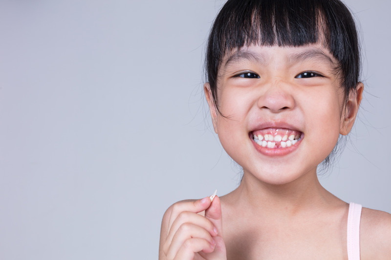 Child smiling after tooth extraction