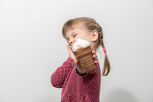 Little girl refusing ice cream because her teeth are sensitive