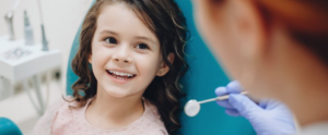 Little girl smiling for her pediatric dentist