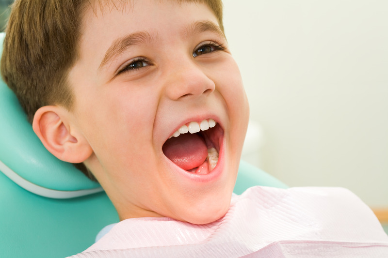 Child smiling after getting dental sealants